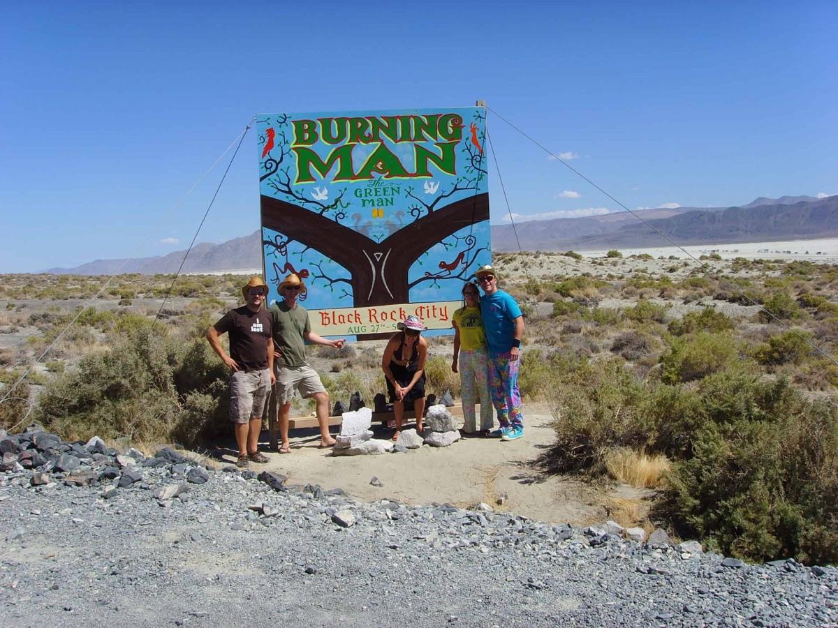 Dave McComb and friends at the Burning Man entrance sign, Black Rock City