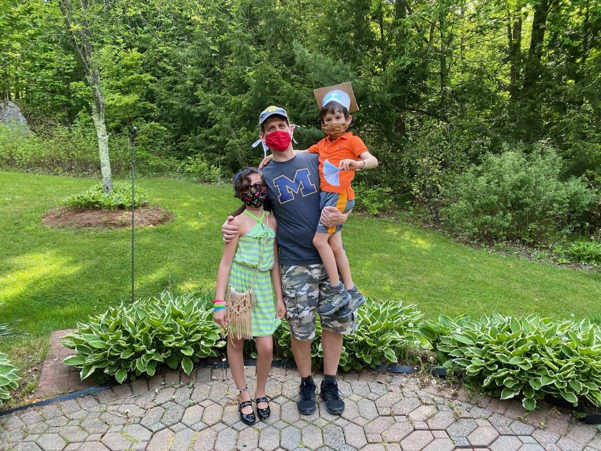 Dave McComb with his two children, wearing a Michigan shirt